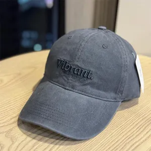Dark grey washed cotton baseball cap with embroidered lettering and wide brim for daily wear detail.