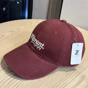 Burgundy baseball cap for women with deep crown and wide brim for stylish sun protection.