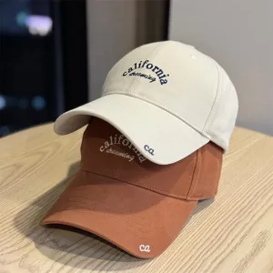 Detailed shot of casual baseball caps with california embroidery, soft top design, two colors.