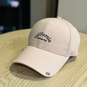 Detailed view of the casual beige soft-top baseball cap with chic front embroidery.