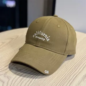 Retro khaki baseball cap detail shot showing embroidery design on soft top and wide brim.