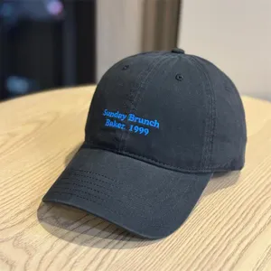 Classic black cotton baseball cap with blue embroidered text, soft top and curved brim for casual wear.