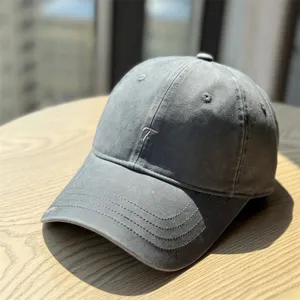 Grey washed cotton baseball cap with embroidered letter T, casual outdoor sun protection hat.