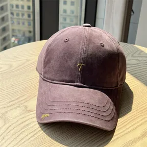Vintage washed cotton baseball cap with embroidered letter T detail for casual daily wear.