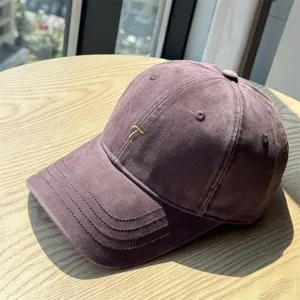 Detailed view of vintage washed cotton baseball cap featuring embroidery for sun protection.