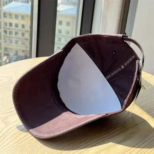 Washed cotton baseball cap for casual daily wear, adjustable metal buckle, brown color.