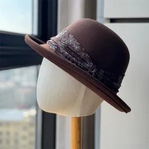 Close up detail view of the retro brown wool felt dome hat featuring a paisley ribbon band.