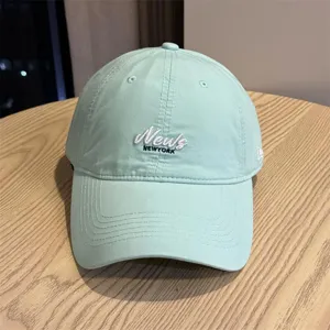 Light green baseball cap detail view, soft crown curved brim for casual outdoor daily wear.