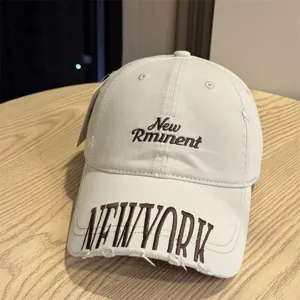 Washed distressed vintage baseball cap with letter embroidery, unisex streetwear style.