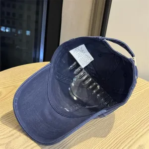 Close-up view showing the inner lining and washing label of the navy blue baseball cap.