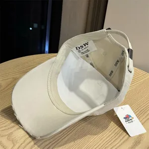 Washed vintage baseball cap detail shot showing inner label, 100% cotton fabric and DSW logo.