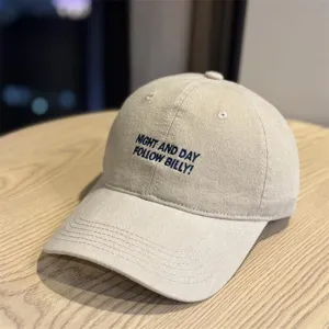 Vintage washed cotton baseball cap with embroidered letter design, casual soft top dad hat.