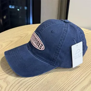 Vintage washed cotton baseball cap with embroidered patch and curved brim for casual daily wear.