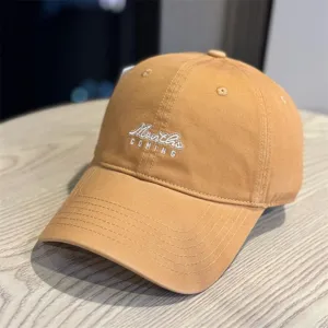 Detail shot of washed cotton baseball cap with stylish embroidery, soft crown and curved brim.