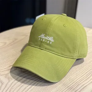 Classic washed green baseball cap with embroidered lettering, soft crown design for casual wear.