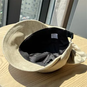 Retro Japanese newsboy hat interior detail showing wash label, bow and adjustable strap.