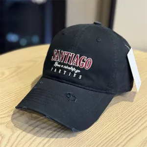 Detailed view of the black distressed baseball cap featuring cool embroidered lettering & brim.
