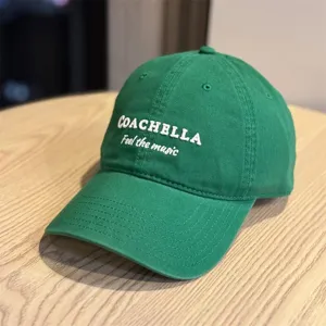 Green cotton baseball hat featuring white embroidered Coachella text and music slogan.