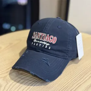 Distressed navy blue baseball cap featuring front SANTIAGO embroidery and worn-out details.