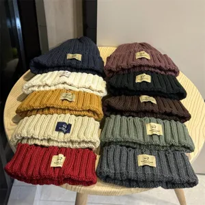 Detailed view of Korean style cute sheep patch knitted beanie hats for warm winter wear.