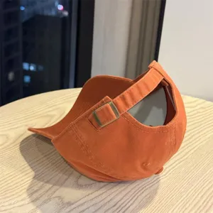Orange baseball cap detail showing adjustable metal buckle and strap construction.