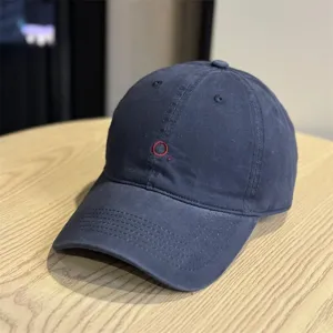 Classic dark blue minimalist dad hat with subtle red embroidery detail, premium cotton cap.