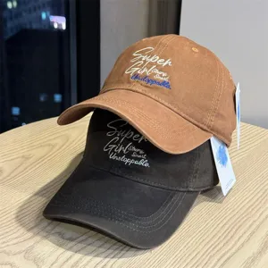 Detailed view of casual embroidered baseball caps in brown and black with inspiring text.