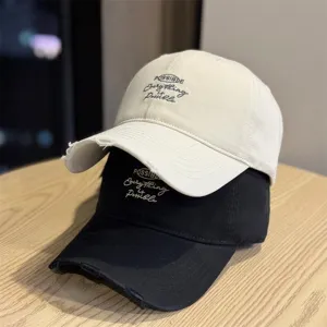 Distressed embroidered baseball cap featuring soft top design and curved brim for daily wear.