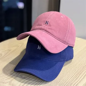 Detail view of casual washed cotton baseball cap featuring soft top design and cute letter embroidery.