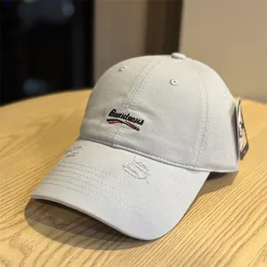 Detailed view of the washed grey baseball cap featuring vintage distressed brim and front embroidery.