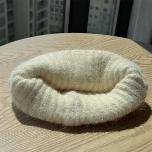 Cozy fuzzy knitted ring scarf detail shot, warm wool texture accessory for winter outfits.