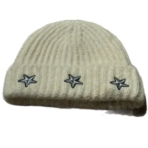 Cozy beige knit beanie featuring stylish star embroidery, perfect for autumn and winter warmth.