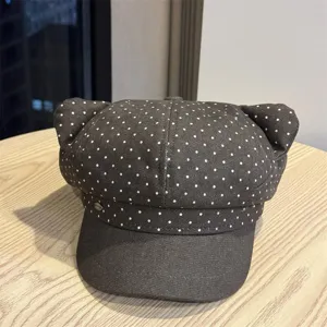 Detail shot of a sweet polka dot newsboy cap with cute cat ears for autumn and winter.