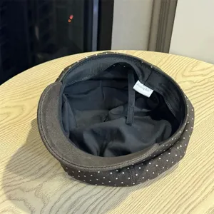 Dark brown polka dot beret hat detail interior view, soft fabric design for women and girls.