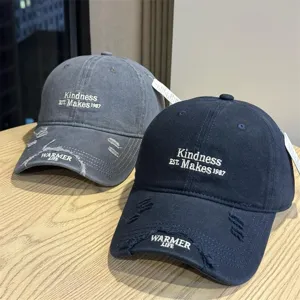 Distressed baseball cap with letter embroidery, stylish distressed brim for sun protection.