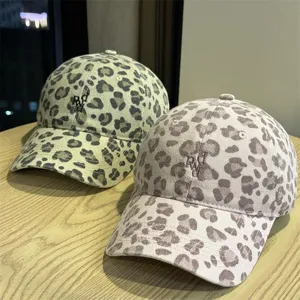 Vista dettagliata del berretto leopardato, design morbido, dettagli con lettere ricamate.