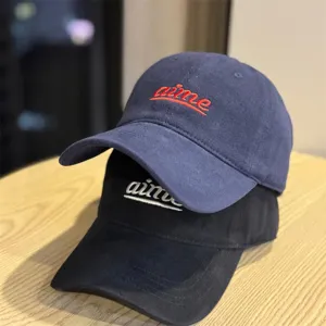 Casual soft top baseball cap with embroidered letter detail, wide brim for sun protection.