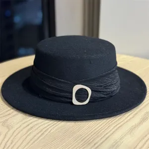 Elegant black woolen flat top hat with stylish pleated band and modern decorative buckle.
