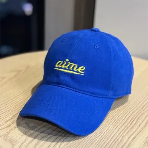 Blue cotton baseball cap with yellow embroidered aime lettering, casual curved brim and soft top.