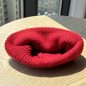 Red knitted beanie detail shot, thick winter warm pull-over hat for women daily wear.
