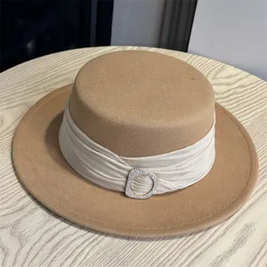Elegant camel wool flat top hat with chic draped satin band and sparkling rhinestone buckle.