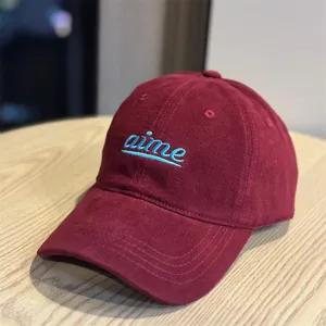 Corduroy baseball cap for men and women, burgundy cap with light blue embroidered logo.