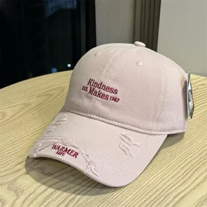 Pink distressed baseball cap with letter embroidery and curved brim for summer casual sun protection.