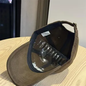 Detailed view of the brown corduroy baseball cap interior showing inner lining and label.