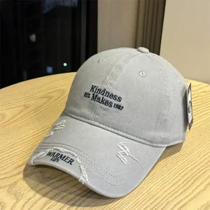 Grey distressed baseball cap with letter embroidery and stylish casual design for summer sun protection.