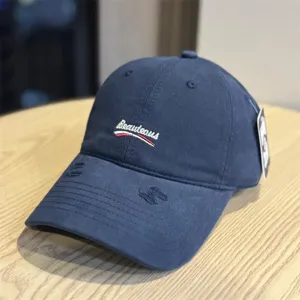 Classic washed cotton baseball cap with embroidered lettering and distressed brim style.