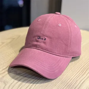Detail view of the autumn minimalist casual embroidered letter baseball cap soft top hat.