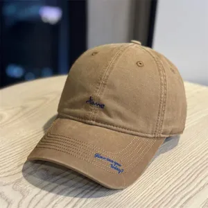 Retro washed cotton baseball cap with blue embroidery, curved brim, casual streetwear sun hat.