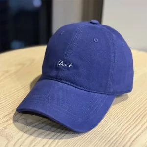 Minimalist blue soft top baseball cap with white embroidered Don't letter, casual unisex sun hat.