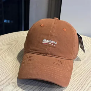 Washed cotton baseball cap for women and men, casual distressed dad hat with embroidered letters.